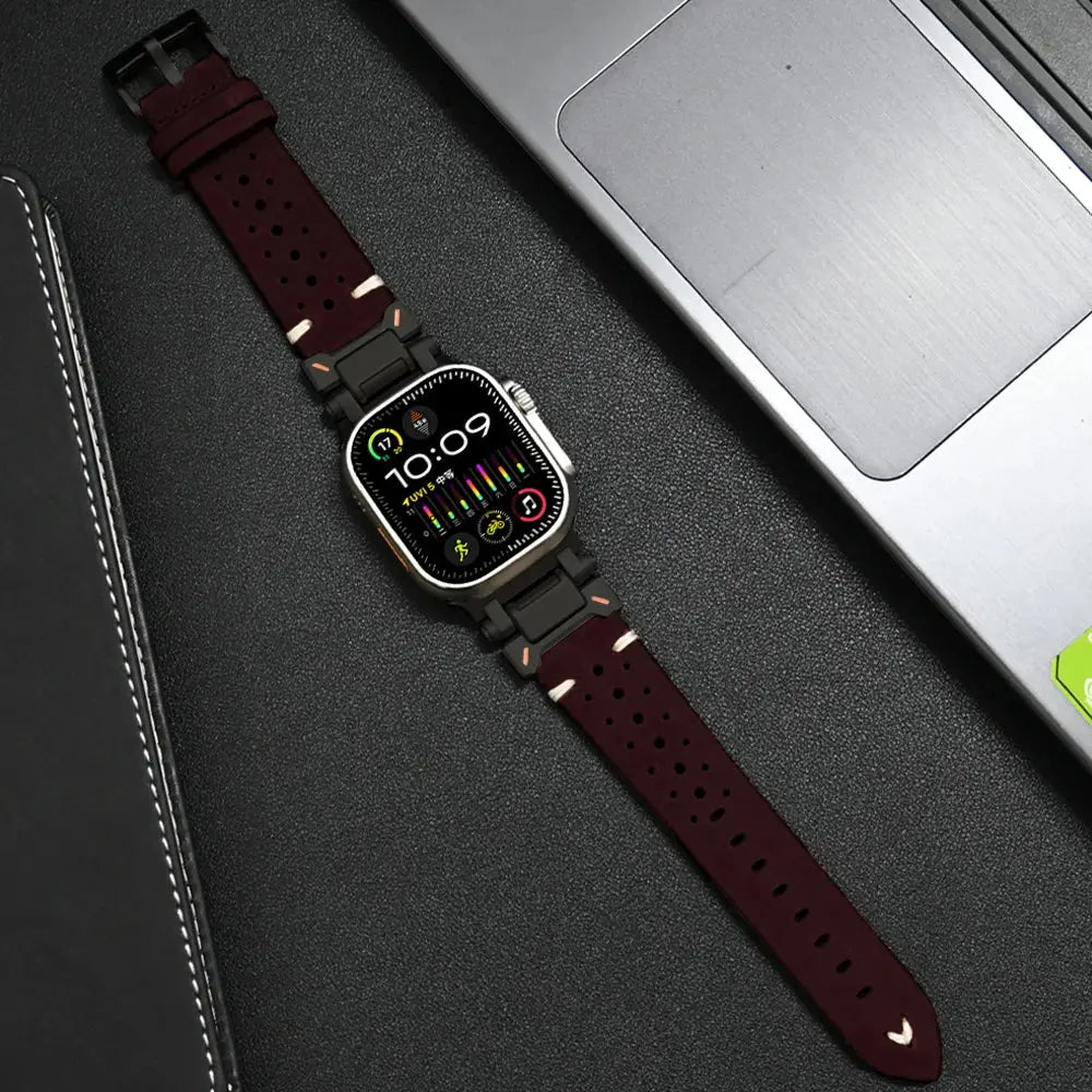 Armor designed leather band for Apple Watch with metal connectors, showcasing rugged style and comfort, placed next to a laptop.