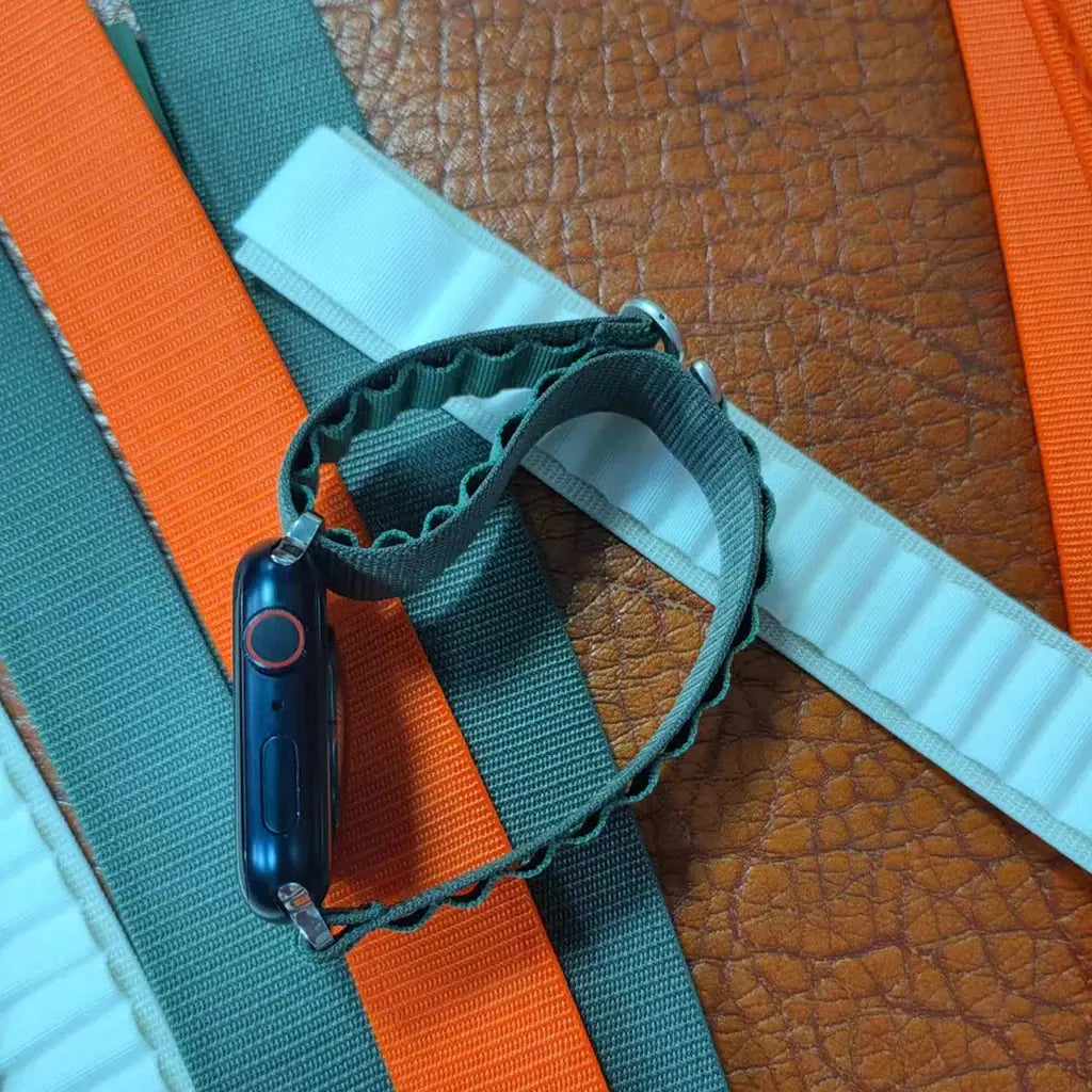 Alpo G Hook Band in rugged textile design, ideal for athletes and fitness enthusiasts, shown with Apple Watch on colorful straps.