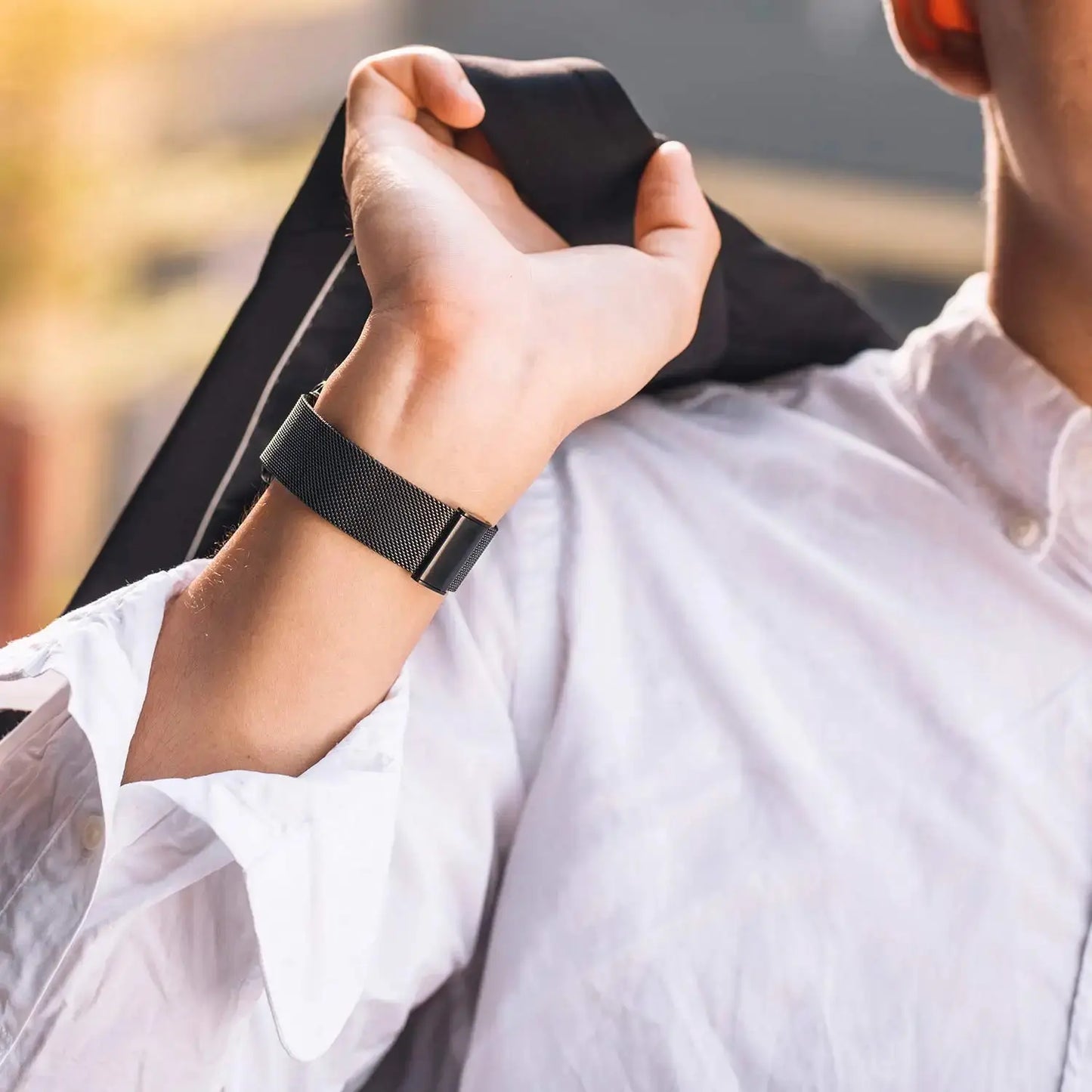 Milanese strap with secure clasp elegantly worn on wrist, showcasing stylish design suitable for Apple Watch.