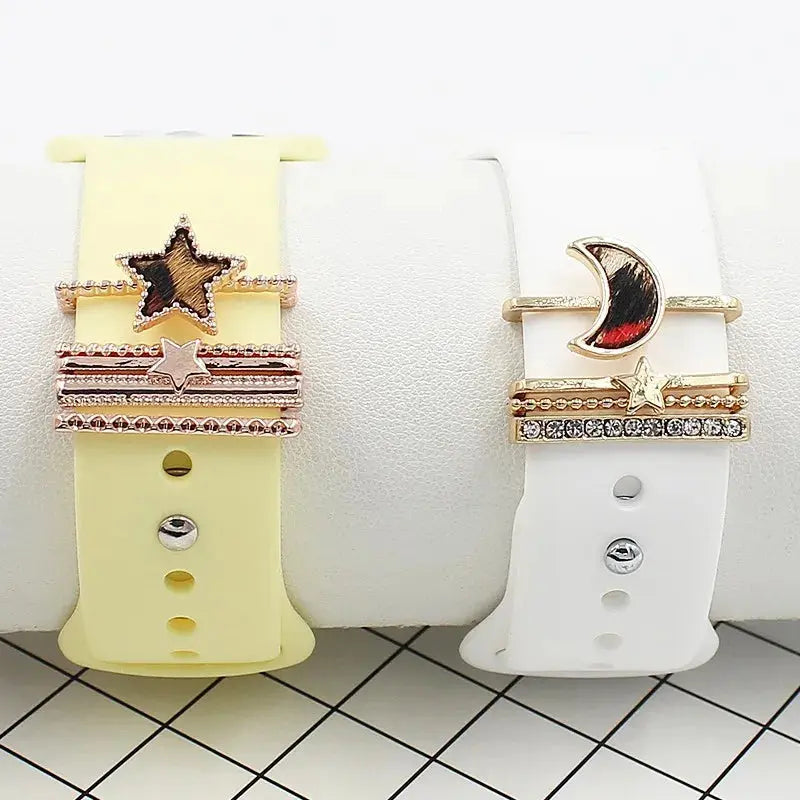 Decorative iWatch band with star and moon loops in gold and silver on yellow and white bands, enhancing elegance and style.
