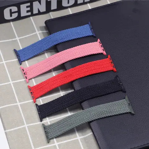 Colorful braided elastic bands for Apple Watch, displaying stylish, durable options in pink, red, navy, black, and green.