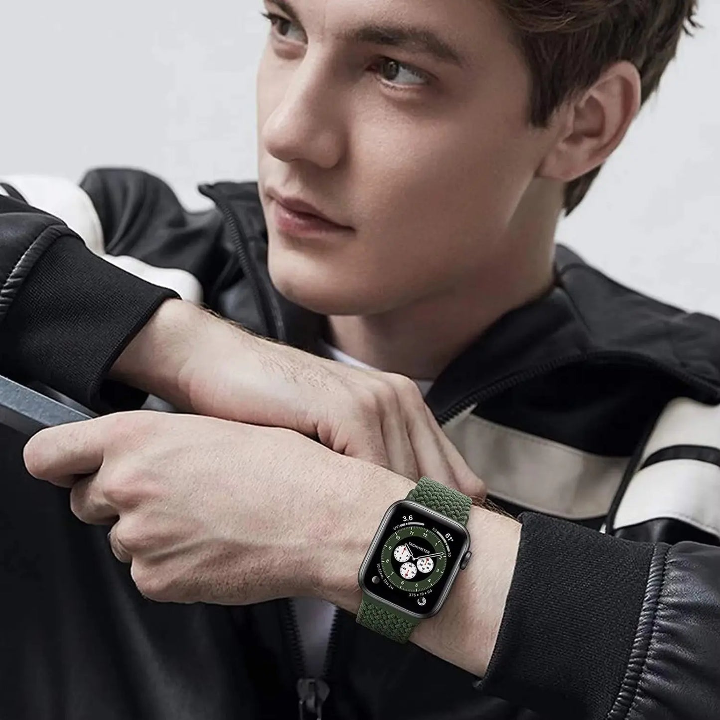 Stylish adjustable braided loop watch band on a young man, showcasing the green stretchable strap and modern design.