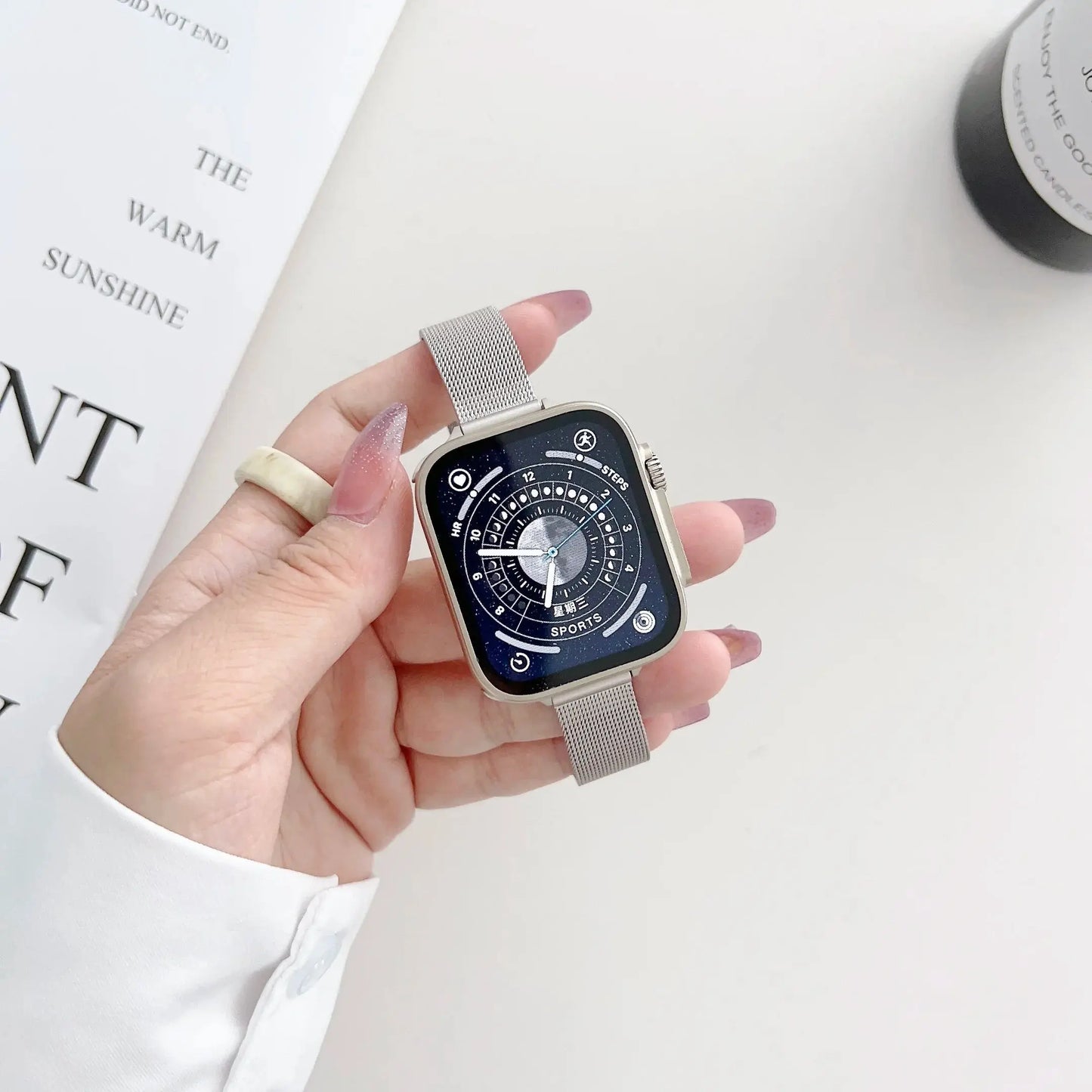 Stylish hand wearing a stainless steel luxury starlight bracelet on an Apple Watch, showcasing its sleek design.