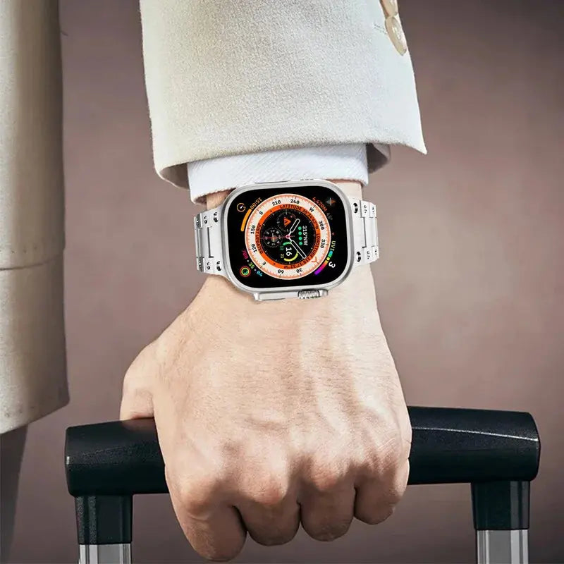 Glossy titanium bracelet on Apple Watch, complementing luxury attire, perfect for travel with a stylish look.