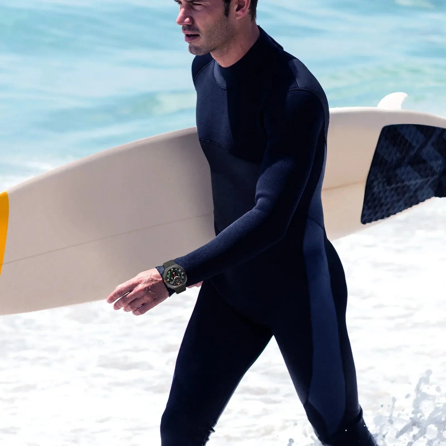 Man wearing rugged silicon band on Samsung Galaxy Watch Ultra, dressed for surfing in ocean waves.
