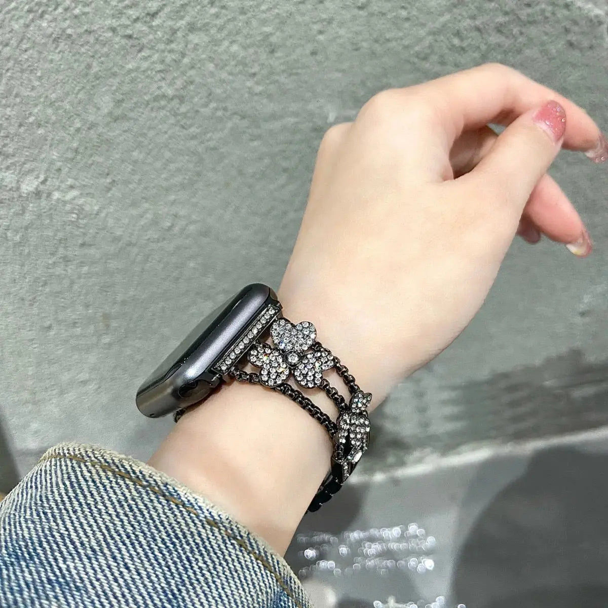 Gorgeous rhinestones bracelet on wrist, elevating Apple Watch with flower pattern and sparkling details.