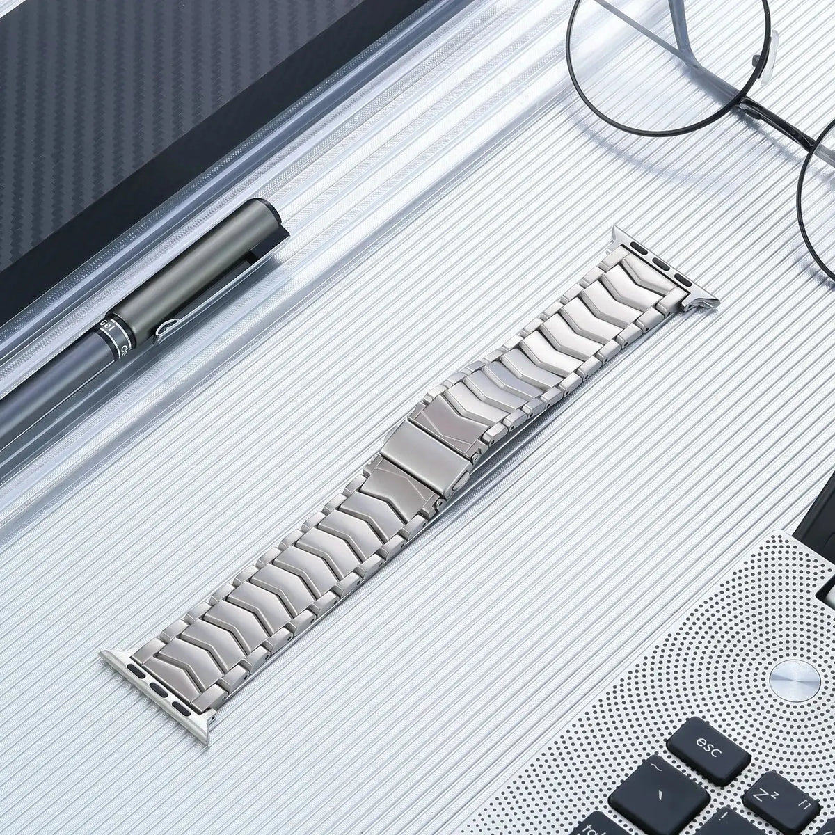 Jack, The Solid Titanium Band displayed on a sleek desk, showcasing its premium titanium build and design.