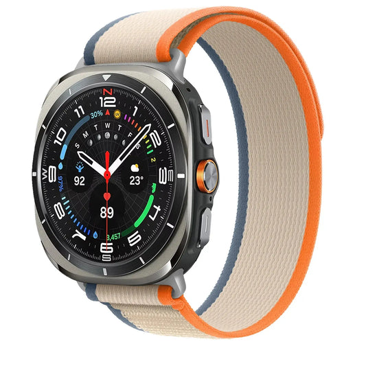 Galaxy Watch Ultra with soft stretchy nylon trail bands in beige and orange, perfect for active lifestyles.
