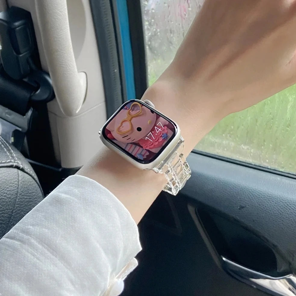 Clear Apple Watch Strap on wrist showing stylish transparent design and Hello Kitty watch face in a car setting.