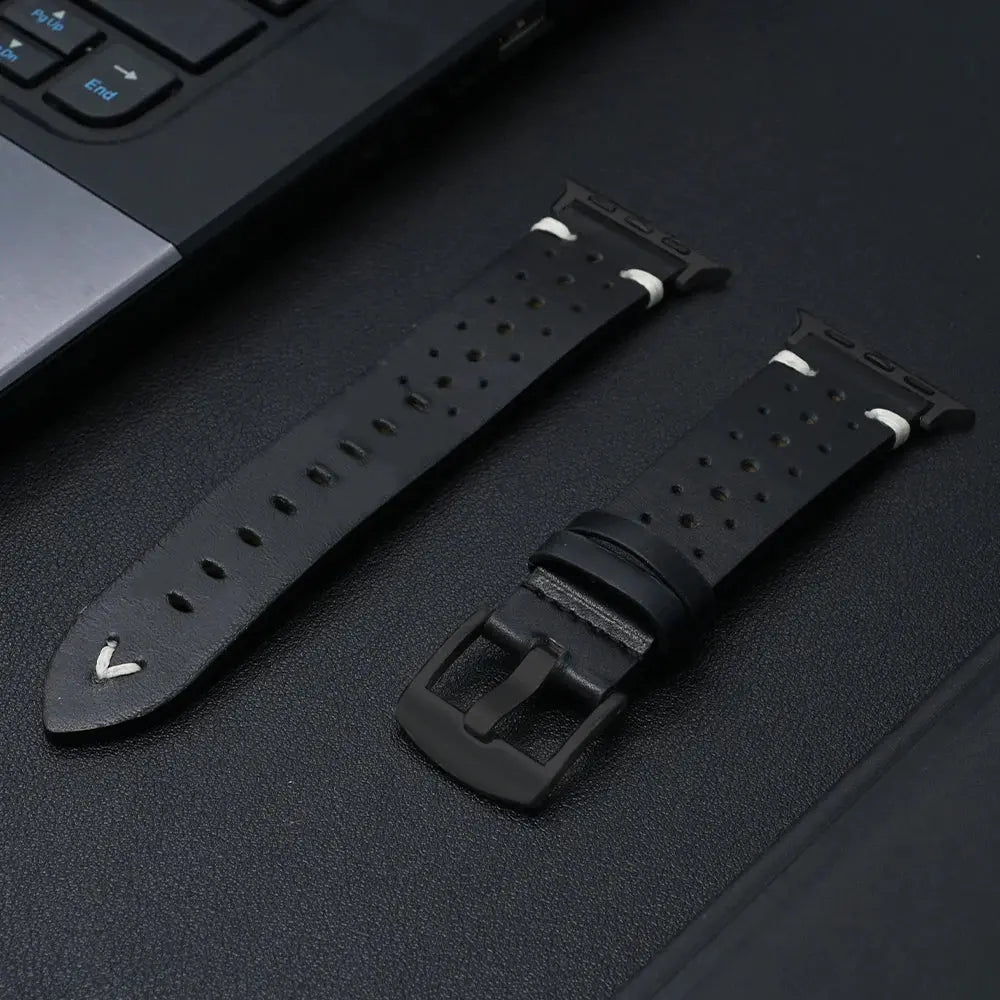 Enzo Classic Leather Band in black, showcasing premium full-grain leather and perforations for airflow, placed next to a laptop.