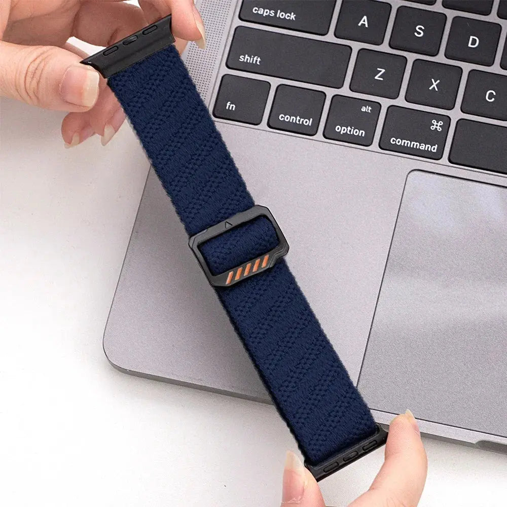 Dennis, The Stretchy Elastic Band in navy, showcasing its adjustable clasp on a laptop.