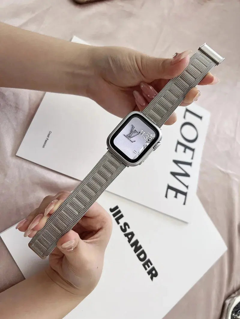 Modern Milanese bracelet in hand, showcasing its sleek design and secure clasp with an Apple Watch.