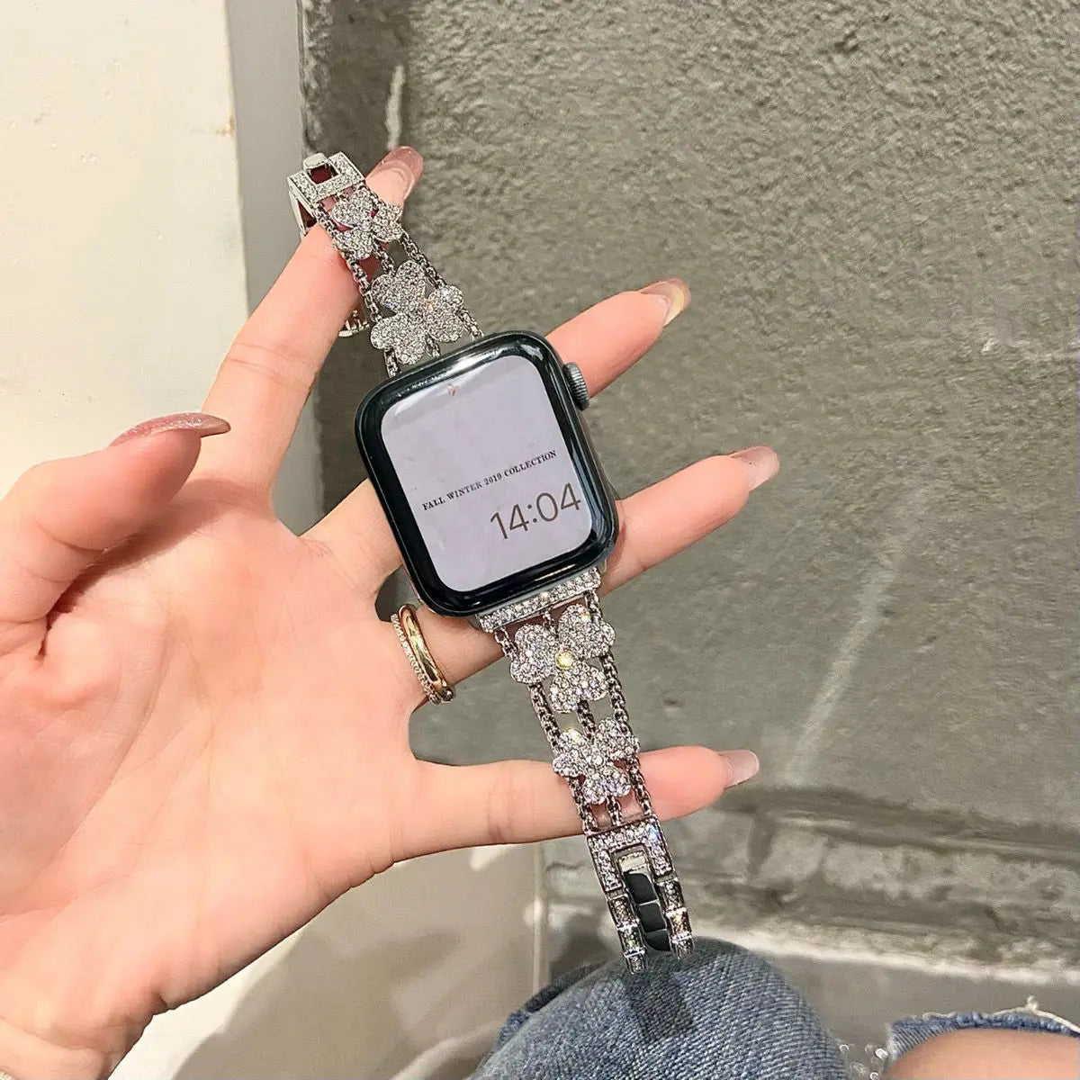 Stylish rhinestones bracelet for Apple Watch in hand, showcasing elegance and glamour, perfect for any occasion.
