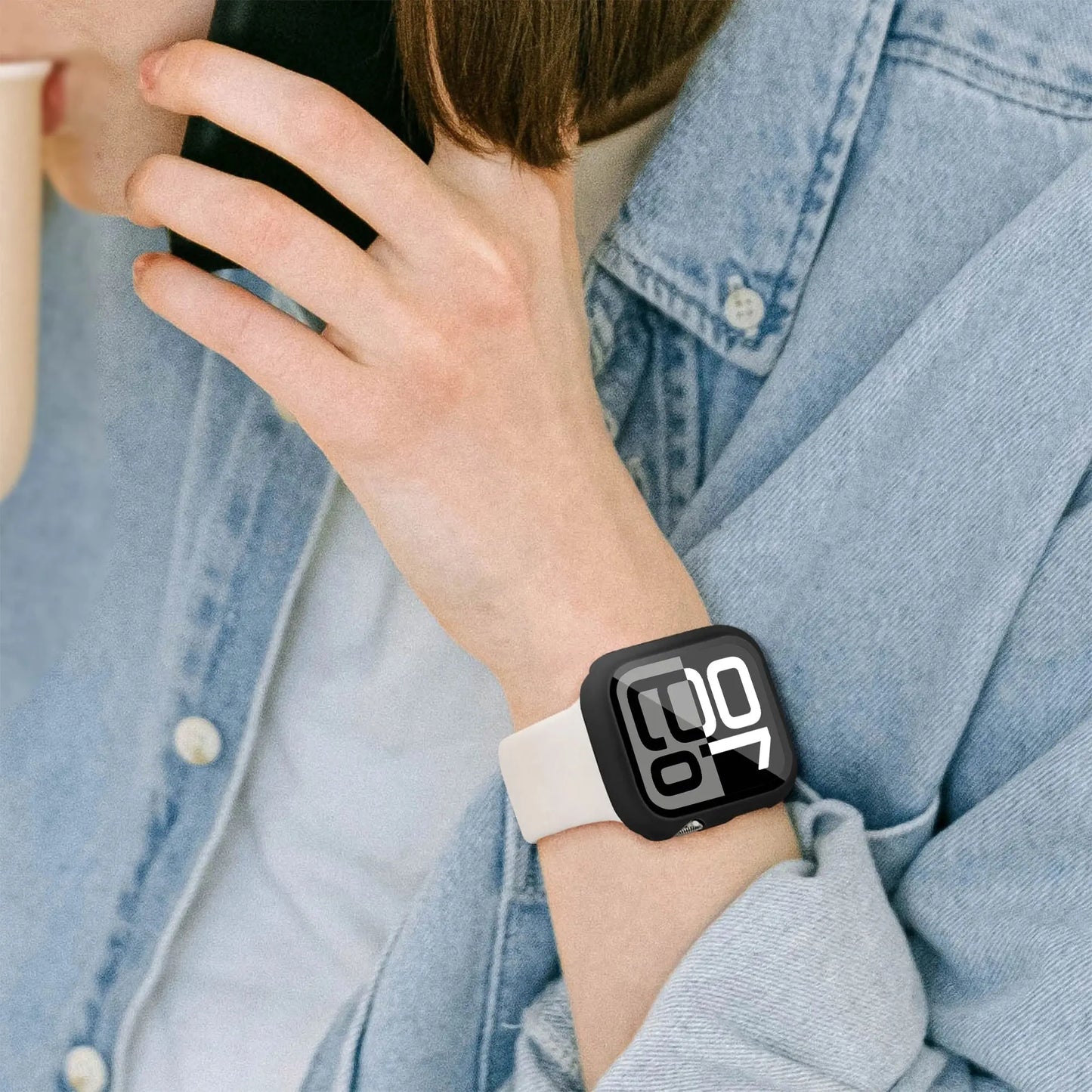 Woman wearing Series 10 watch case with HD glass, showing time display while on phone.