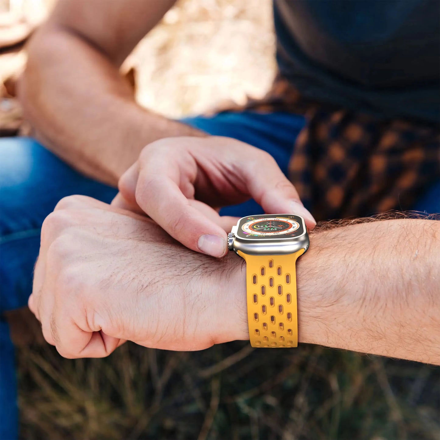 Person wearing a breathable yellow silicone band with magnetic clasp on Apple Watch, perfect for active lifestyles.