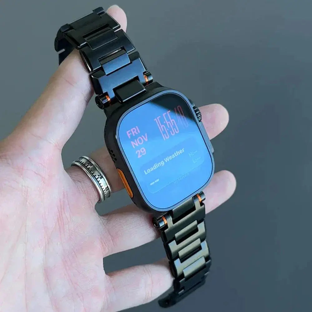 Elegant Cowboy metal Apple Watch band in hand, showcasing sleek design and quick magnetic clasp.