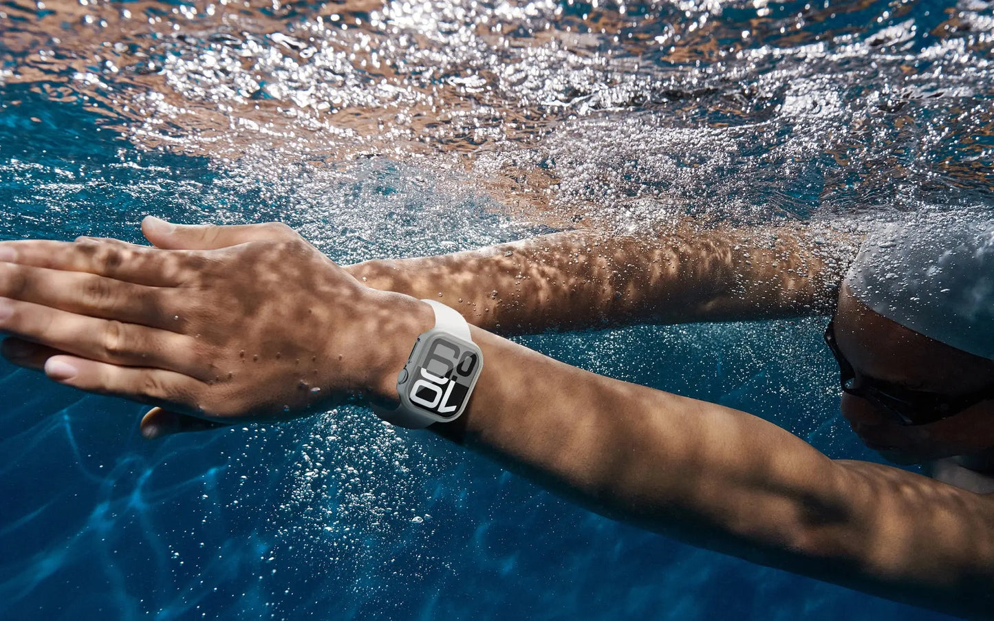 Person swimming underwater wearing a PC protective case on Apple Watch Series 10, showcasing durability and water resistance.