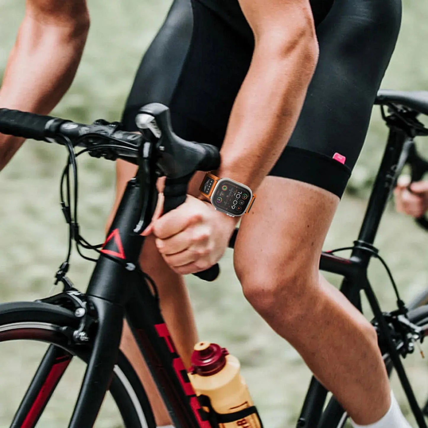 Sport Woven Nylon Band with USA Flag on cyclist's Apple Watch during outdoor biking adventure.