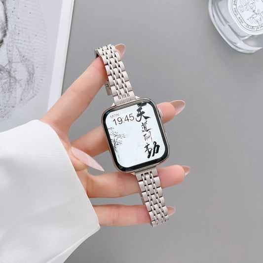 Elegant stainless steel Apple Watch bracelet showcasing a starlight color with a bold design and adjustable strap.