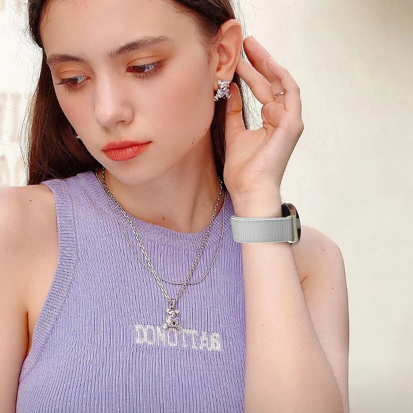 Stylish woman wearing a magnetic nylon band on her Samsung Galaxy Watch, showcasing a sporty look.