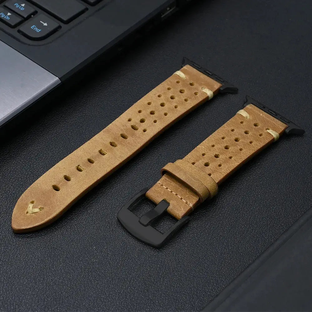 Enzo Classic Leather Band in tan with perforations for airflow, set beside a laptop, showcasing elegance and comfort.
