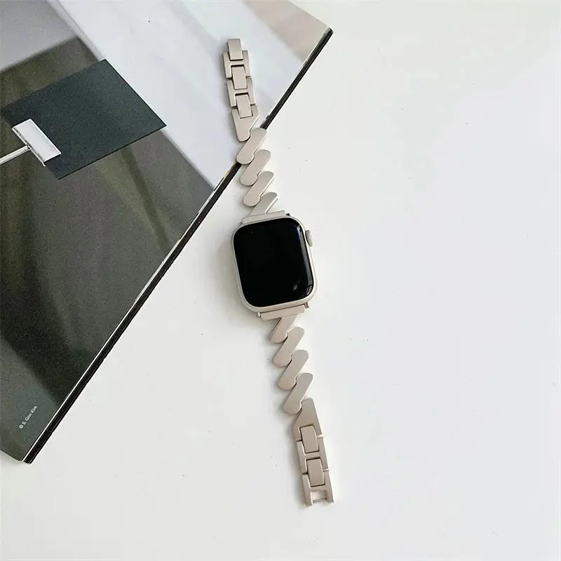 Luxury Starlight Bracelet for Apple Watch on a minimalist table, showcasing a stainless steel design in elegant colors.