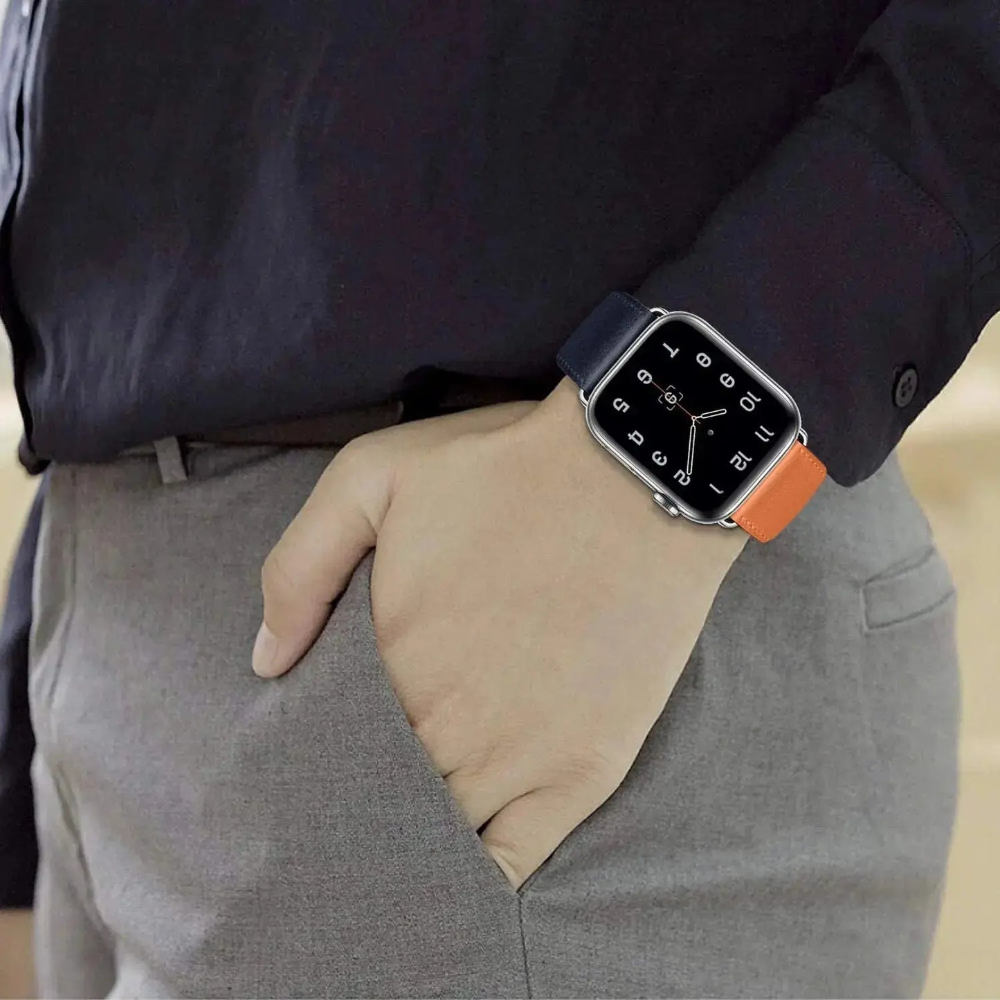 Classic single tour leather strap on an Apple Watch, featuring a stylish navy and orange design, showcasing durability and elegance.