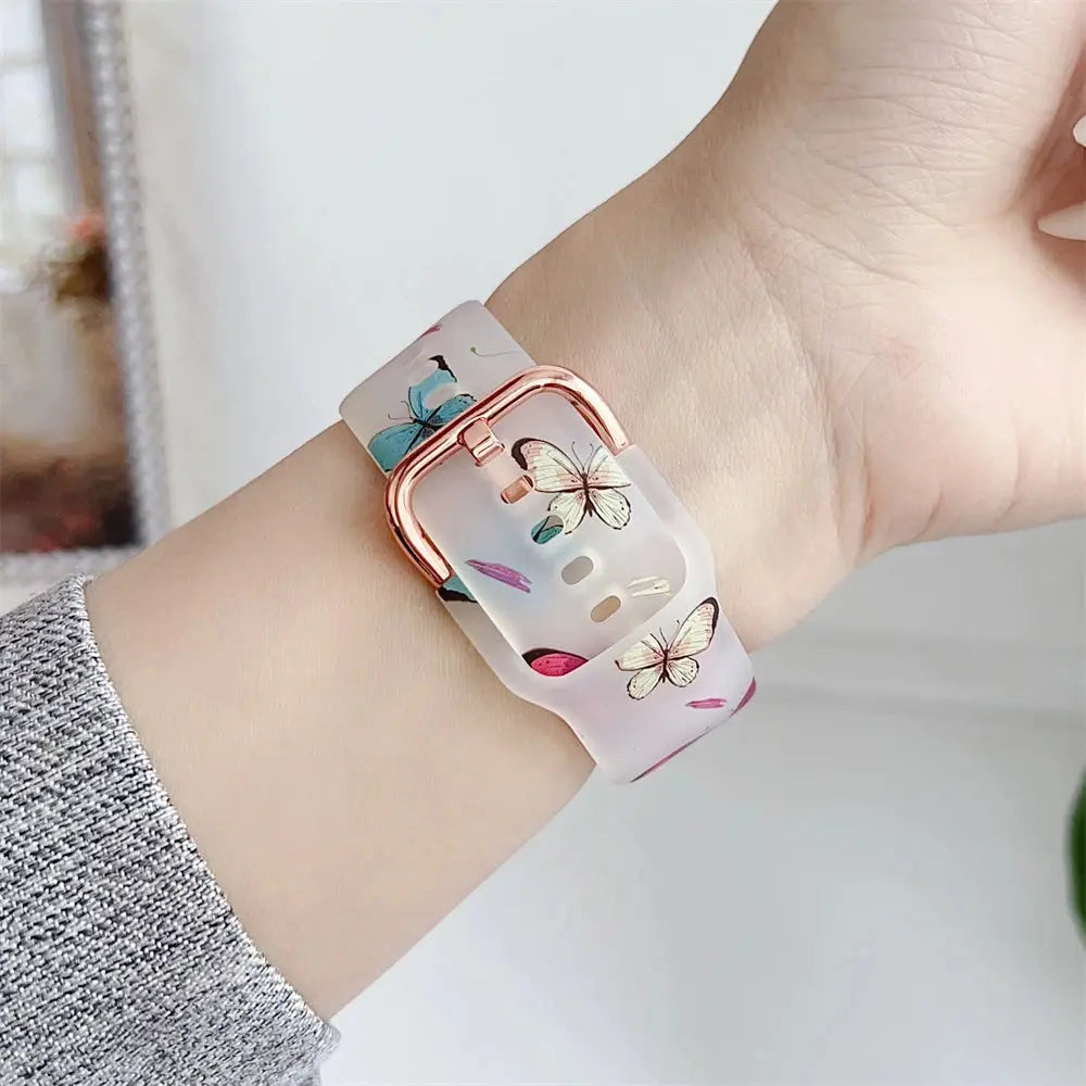 Clear Silicone Apple Watch Band with colorful butterfly and flower design on wrist.