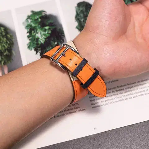 Double Tour Leather Bracelet in orange on wrist, showcasing stylish equestrian design and easy-to-install Apple Watch strap.
