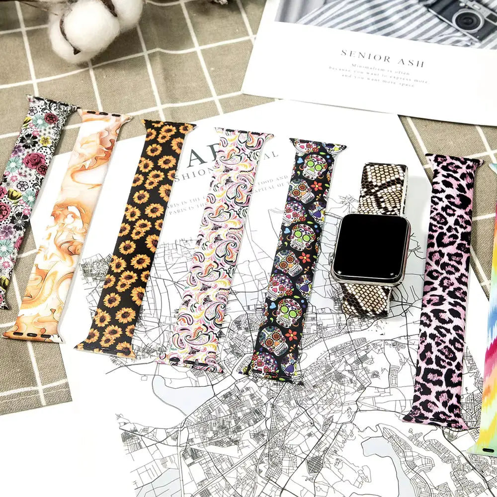 Colorful pattern silicone solo loop bands for smartwatches, showcasing bold designs and styles on a background map.