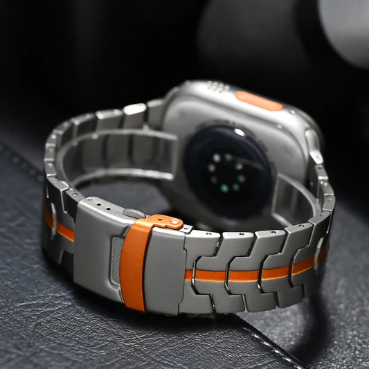 Macho Lux Metal Bracelet for Apple Watch with orange accents, showcasing stylish durability and elegant design.