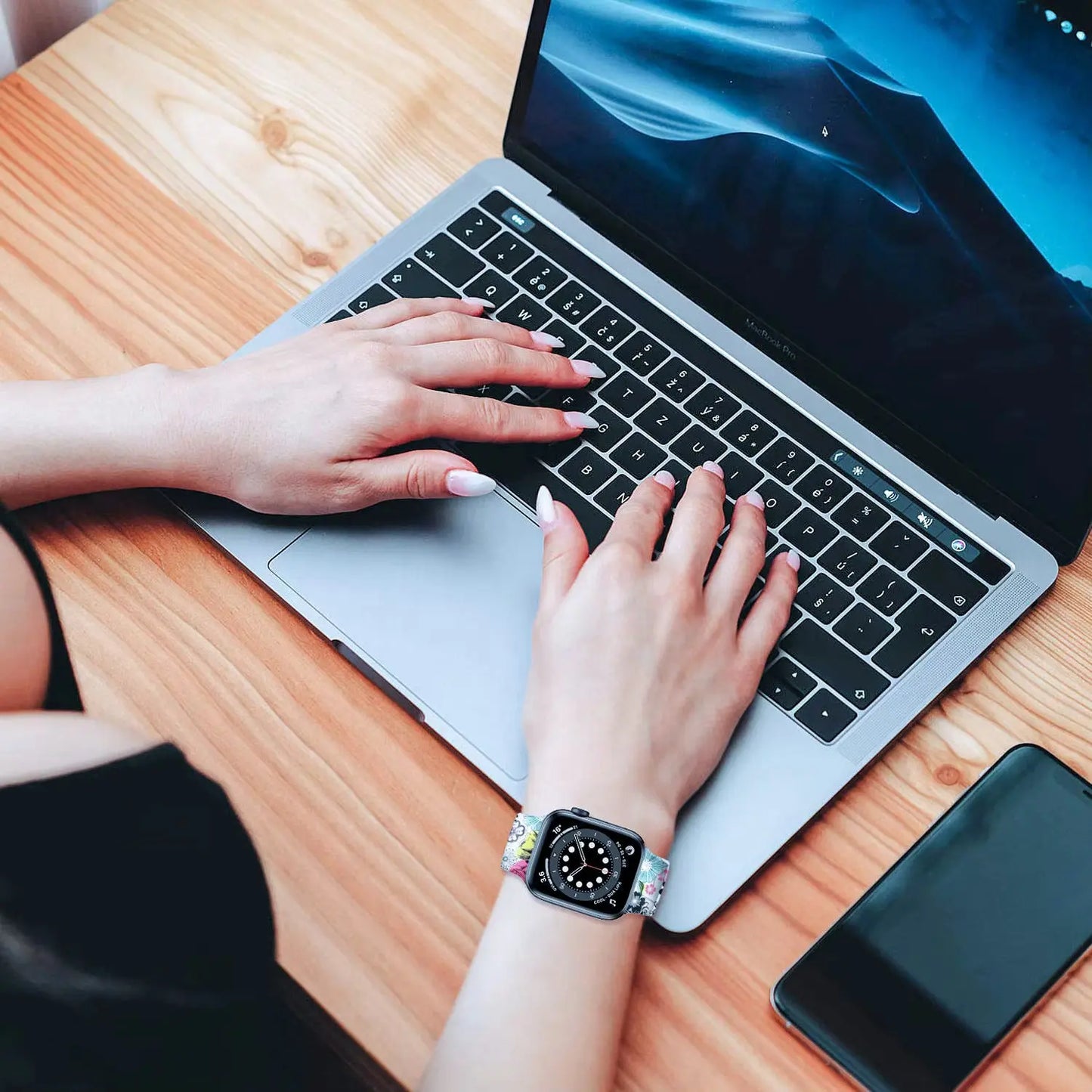 Colorful Pattern Silicon Solo Loop watch band on wrist while typing on a laptop, showcasing trendy accessories.