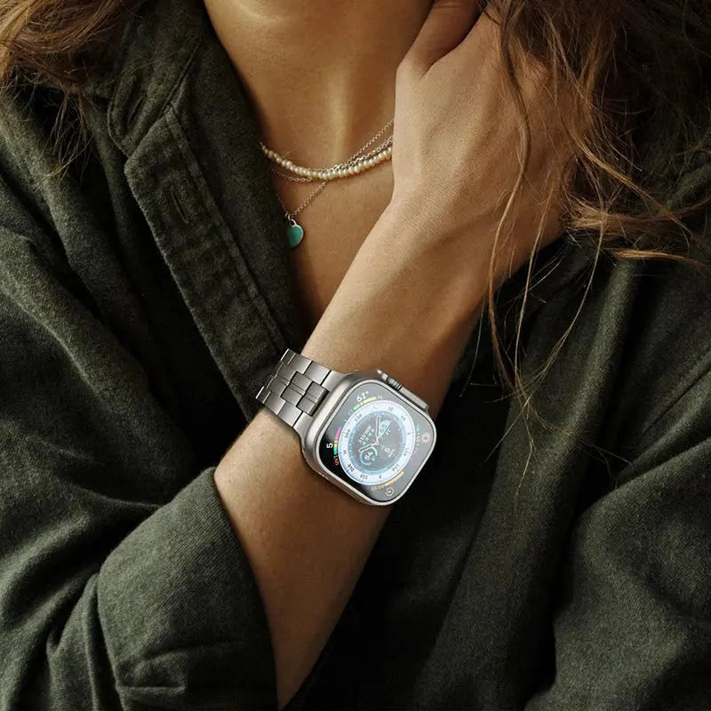 Bold Titanium Bracelet on wrist with Apple Watch, showcasing strength and elegance with sleek satin-brushed finish.