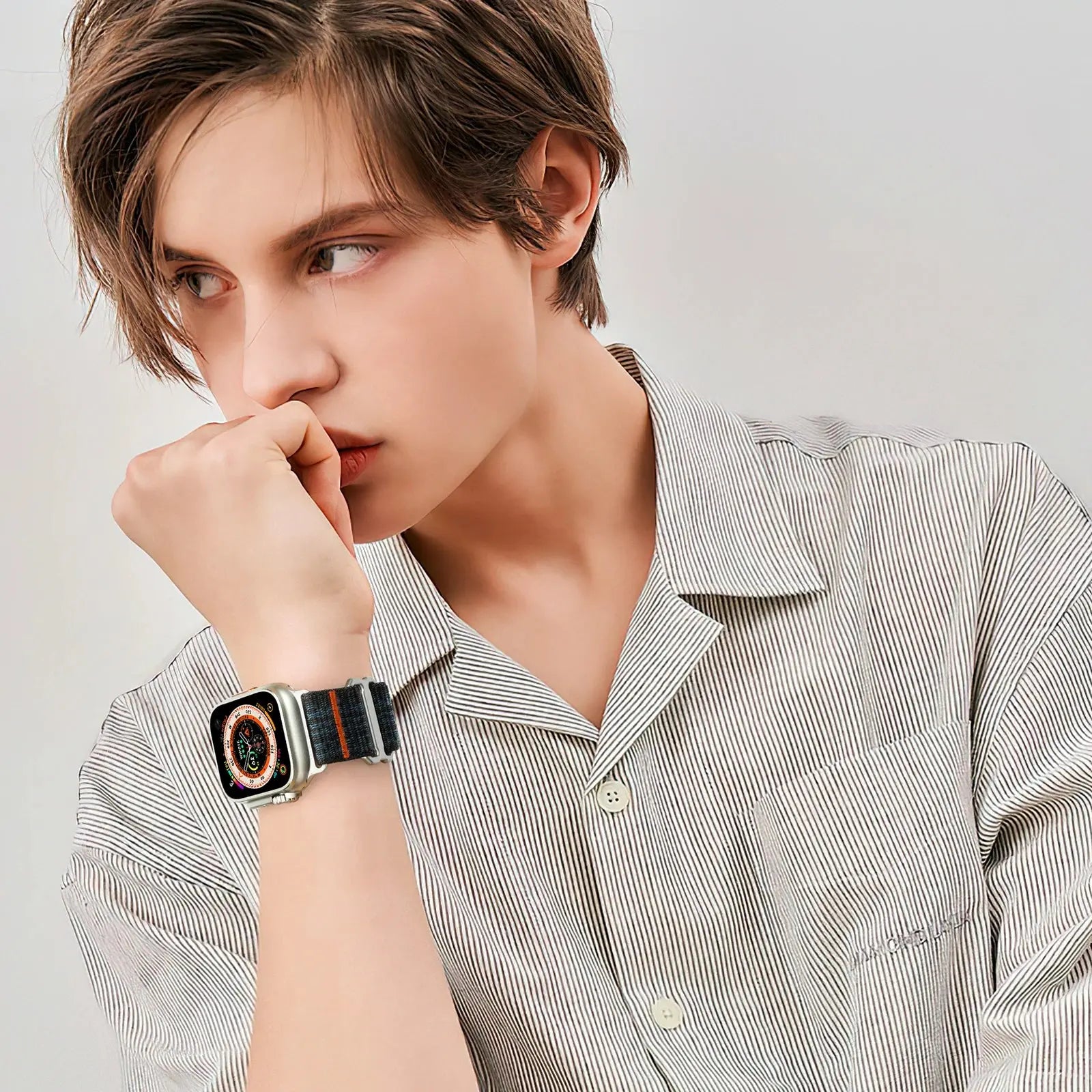 Model showcasing upgraded sport loop band on Apple Watch, featuring a stylish nylon strap and casual attire.