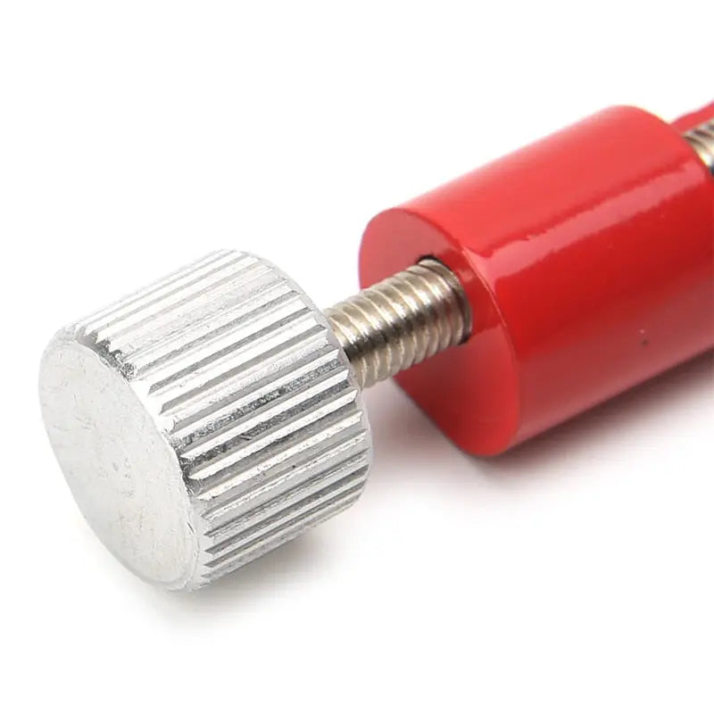 Close-up of the watch link removal tool showing the red handle and silver adjustment knob for easy pin removal.