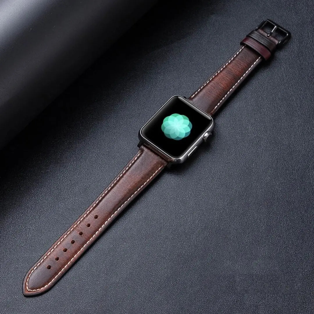 Oil waxed genuine leather Apple Watch band with classic pattern design on a dark background.