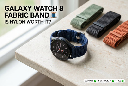 Samsung Galaxy Watch 8 with woven nylon fabric band in navy blue displayed on stone surface surrounded by multiple colorful nylon band options for daily wear