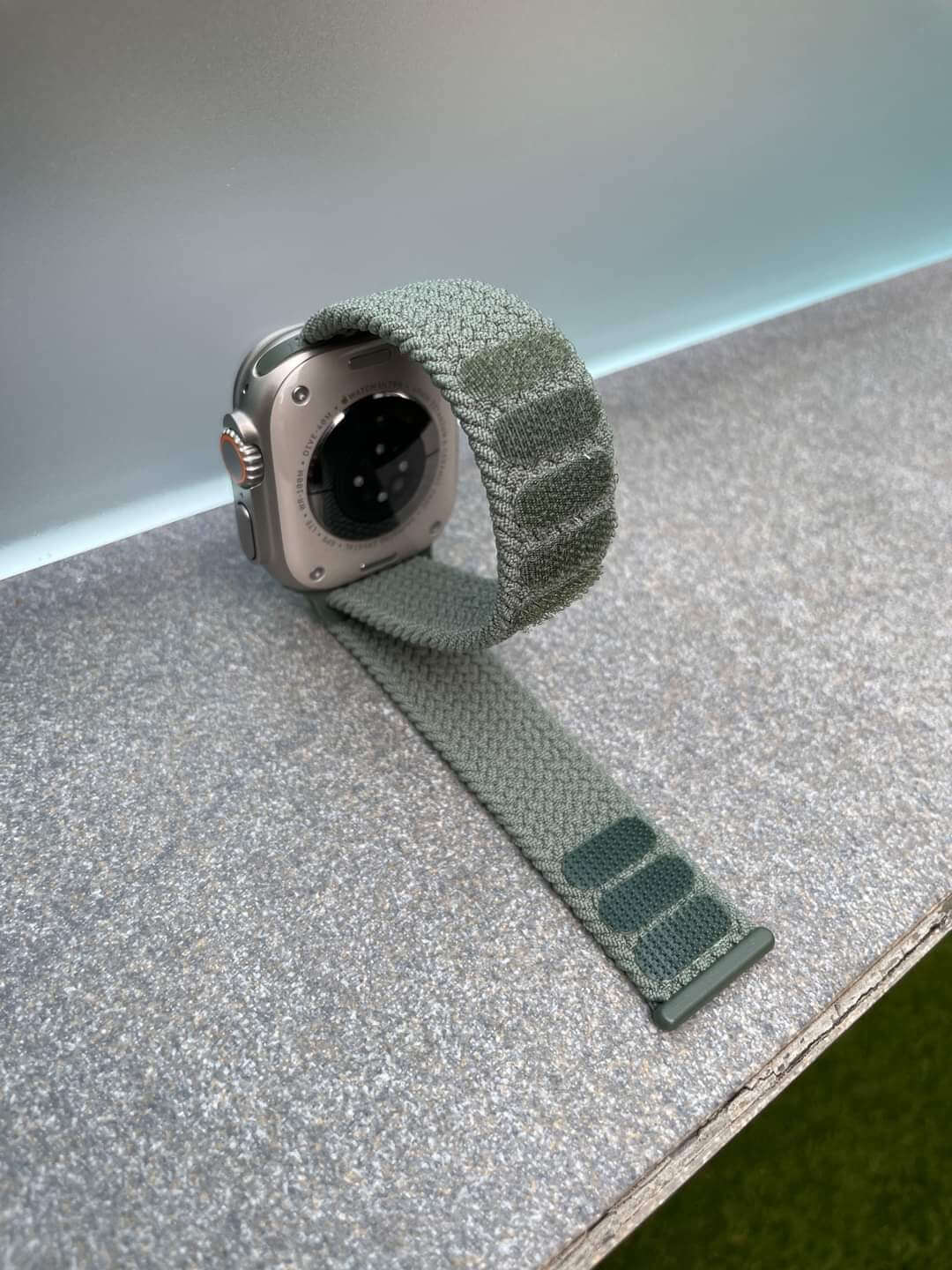 Mint green braided watch band on a sleek surface, perfect for stylish smartwatches and active lifestyles.