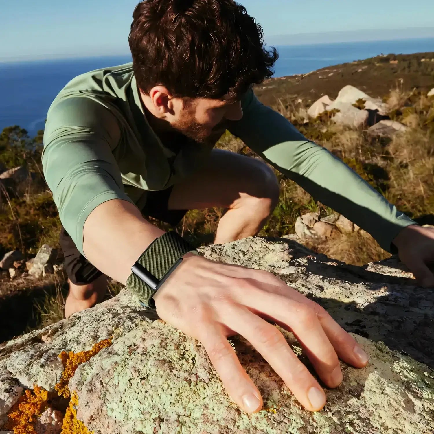 Athlete using a Whoop Band while climbing rocks outdoors, showcasing the band’s sporty and durable design.
