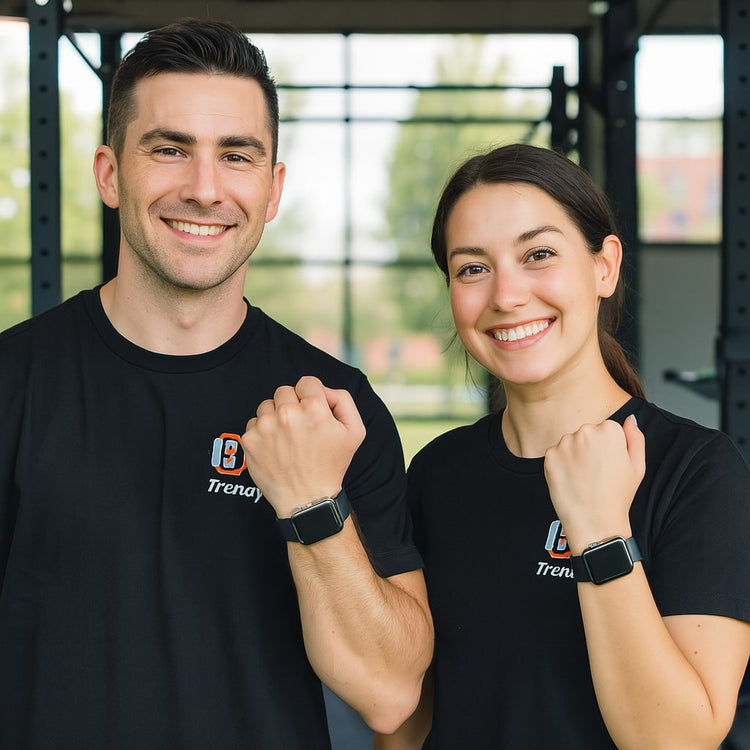 Smiling couple showing off Apple Watch Series 9 bands while wearing matching black t-shirts in a gym setting.