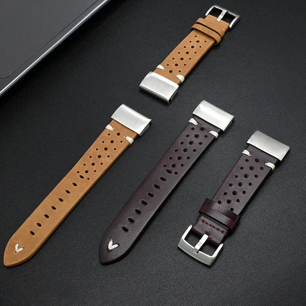 Three leather watch straps with metal buckles on a dark surface