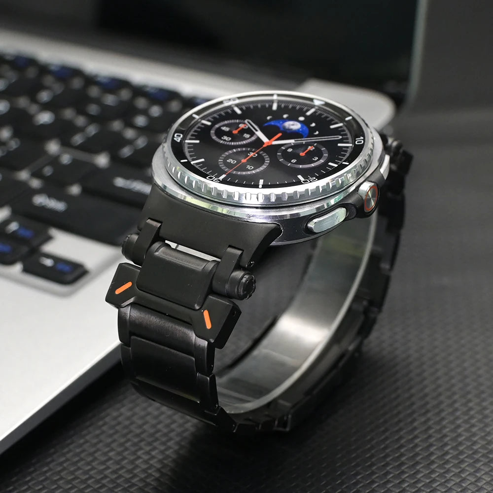 No Gaps Titanium Band for Samsung Galaxy Watch Ultra 47mm on a watch with a black strap next to a laptop.