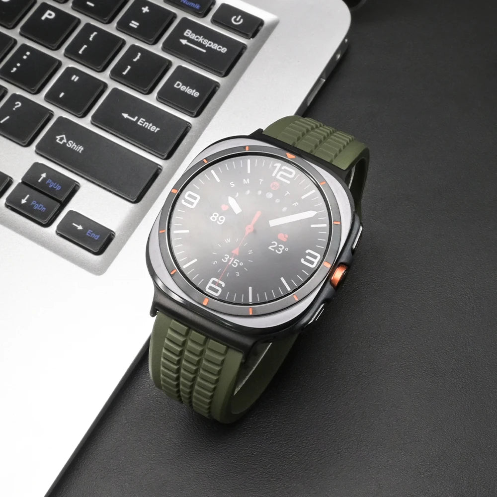Soft Silicone Sport Band for Samsung Galaxy Watch Ultra & 8 in olive green on a laptop desk.