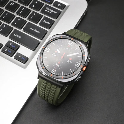 Soft Silicone Sport Band for Samsung Galaxy Watch Ultra & 8 in olive green on a laptop desk.