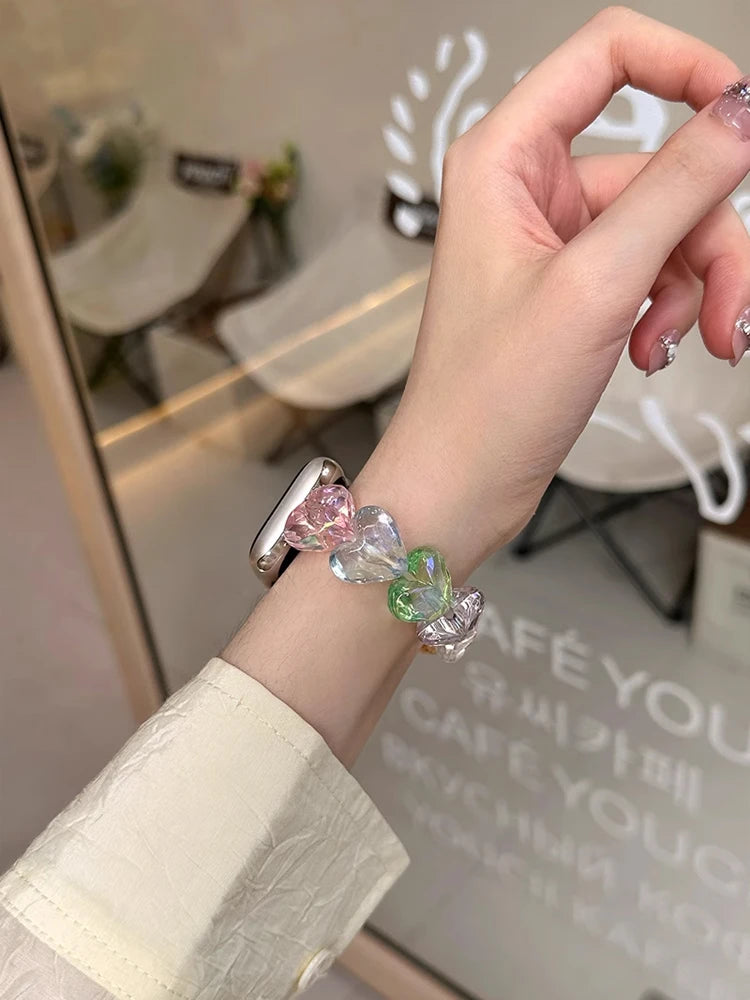 Love Band for Apple Watch – Laser Acrylic Bracelet Strap for Women worn on wrist with iridescent heart-shaped beads.