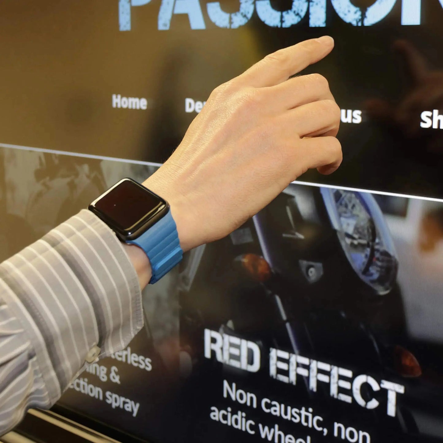 Man wearing an adjustable leather Apple watch band with powerful magnets while interacting with a touchscreen.