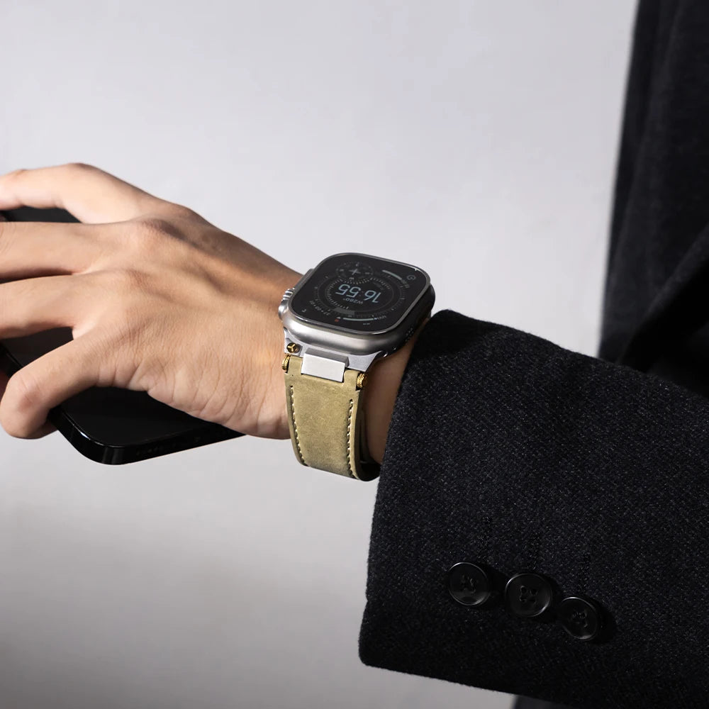 Apple Watch Leather Strap – Luxury Business Band (44–49mm) worn on a hand holding a smartphone, showcasing its elegance.
