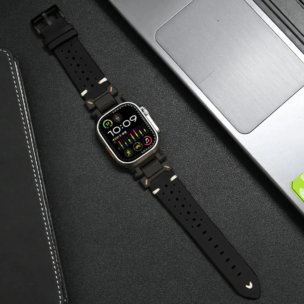 Stylish Armor Designed Leather Band for Apple Watch on a laptop, featuring high-quality metal connectors and breathable holes.
