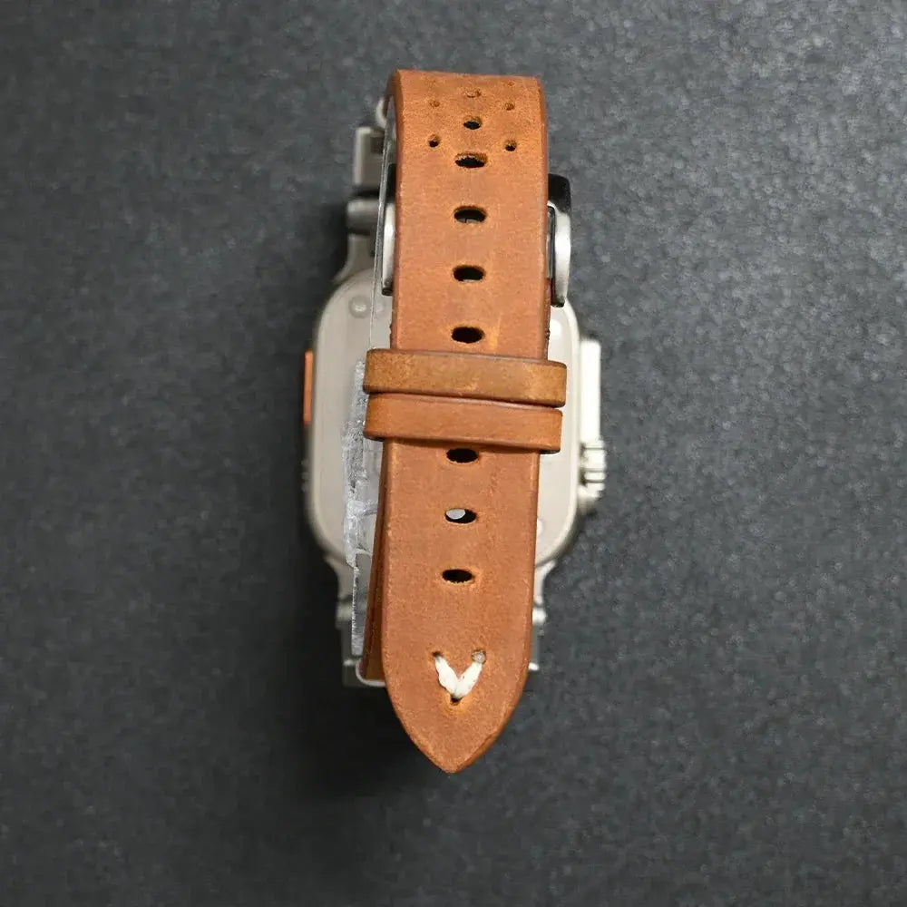 Top view of Armor Designed Leather Band for Apple Watch with sleek metal accents and breathable holes for comfort.