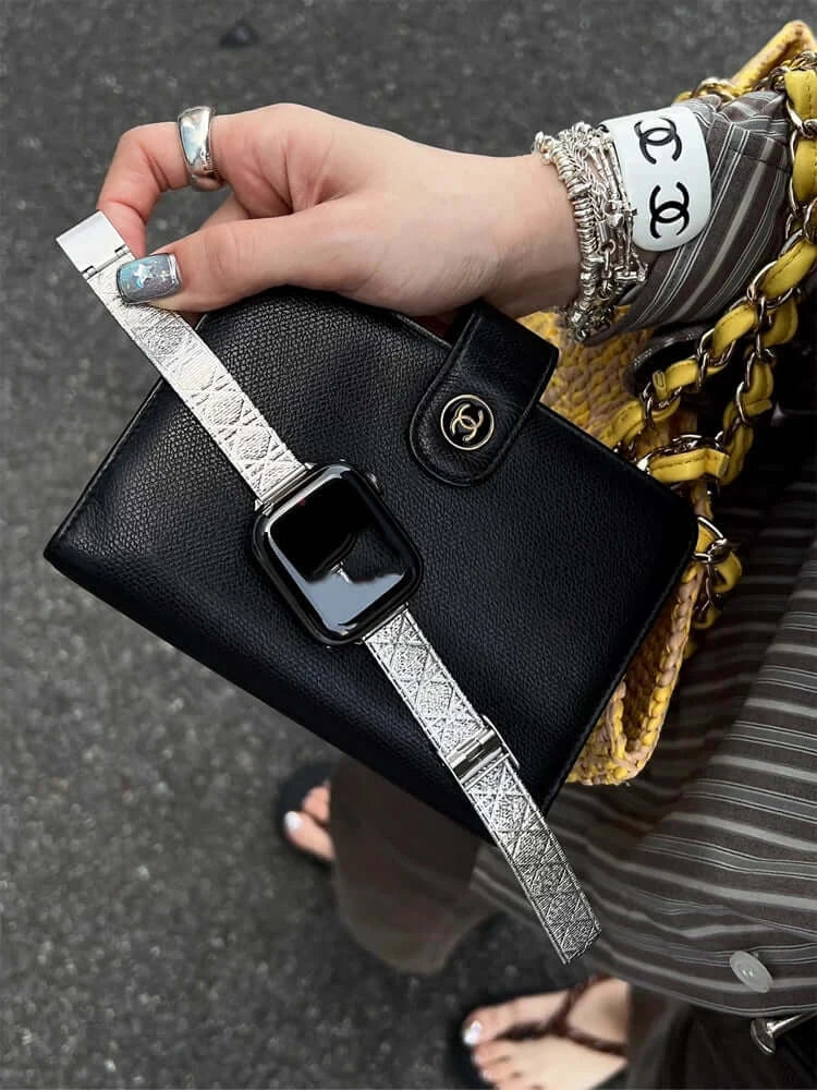 Glossy Stainless Steel Apple Watch Band – Slim Women’s Metal Strap (38–49mm) stylishly paired with a chic black bag.